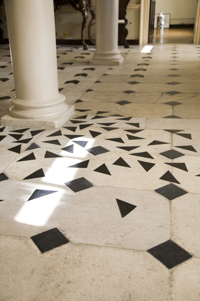 black and whiote marble floor with added black paper triangles